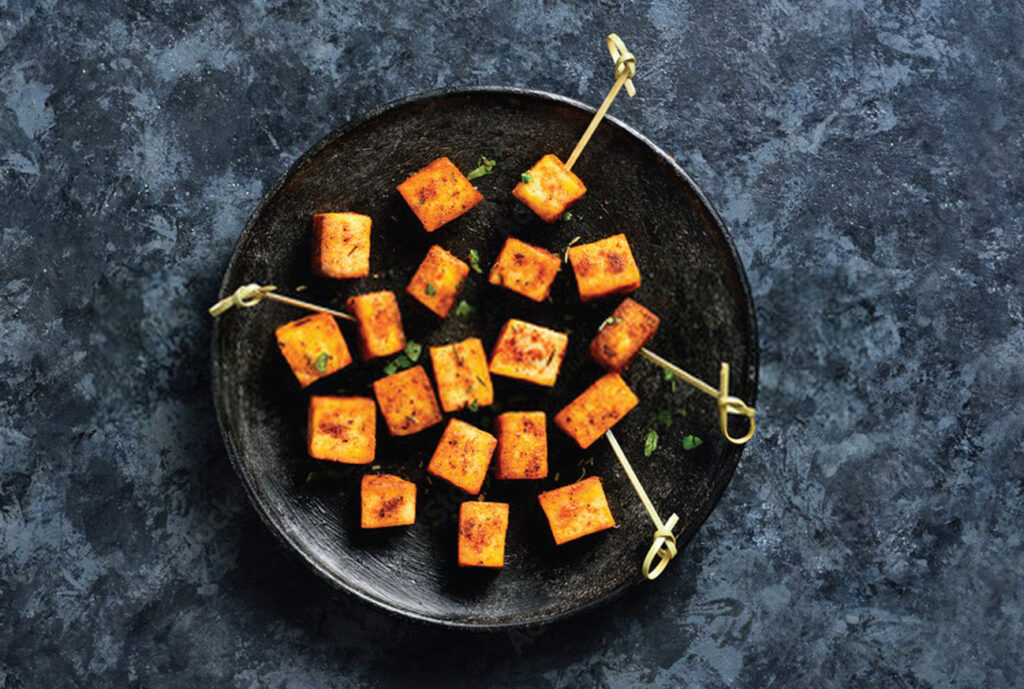 Plate of spicy fried paneer cubes.