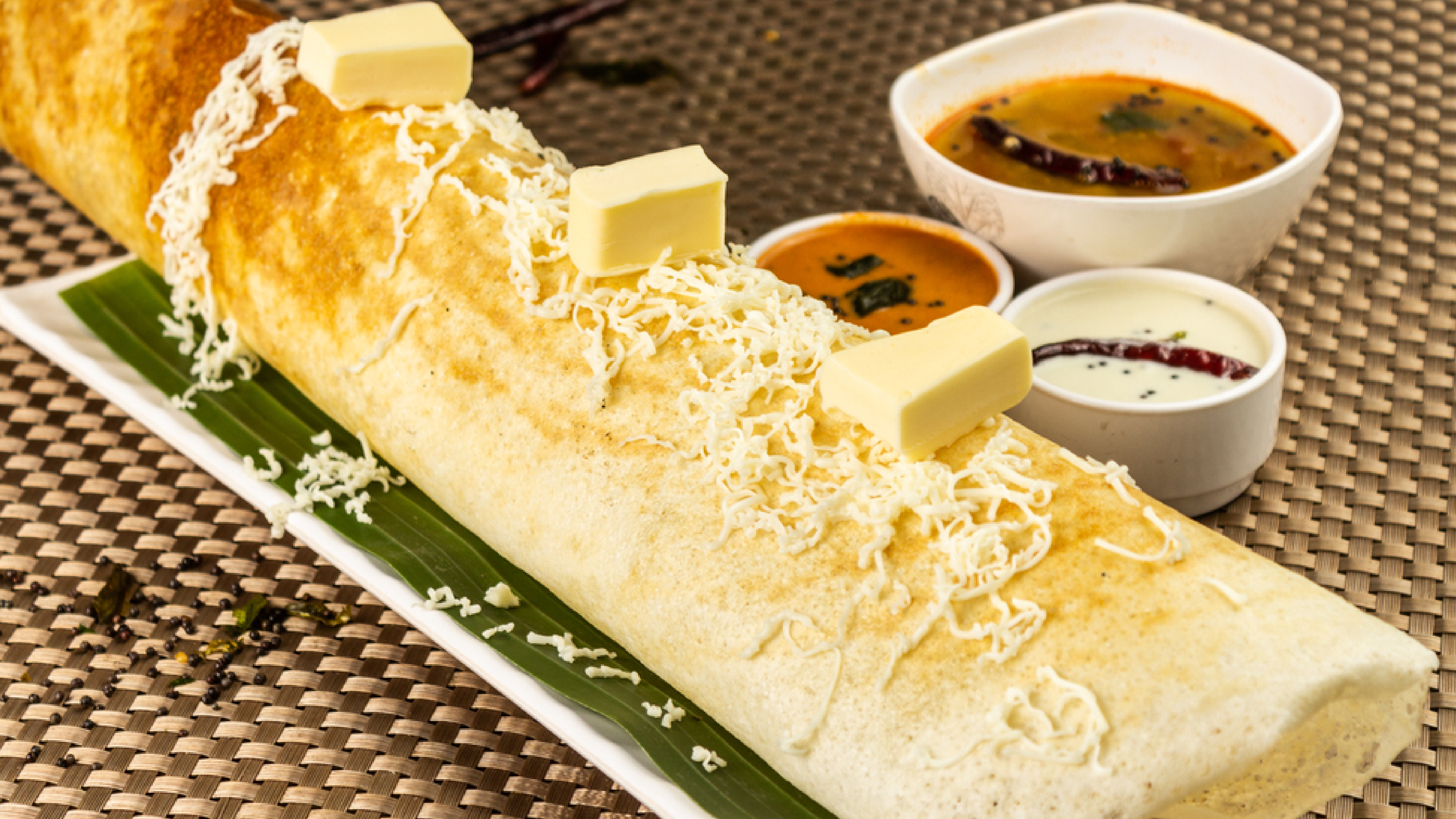 It is a blog image displaying the best cheese dosa in austin with different chutneys.