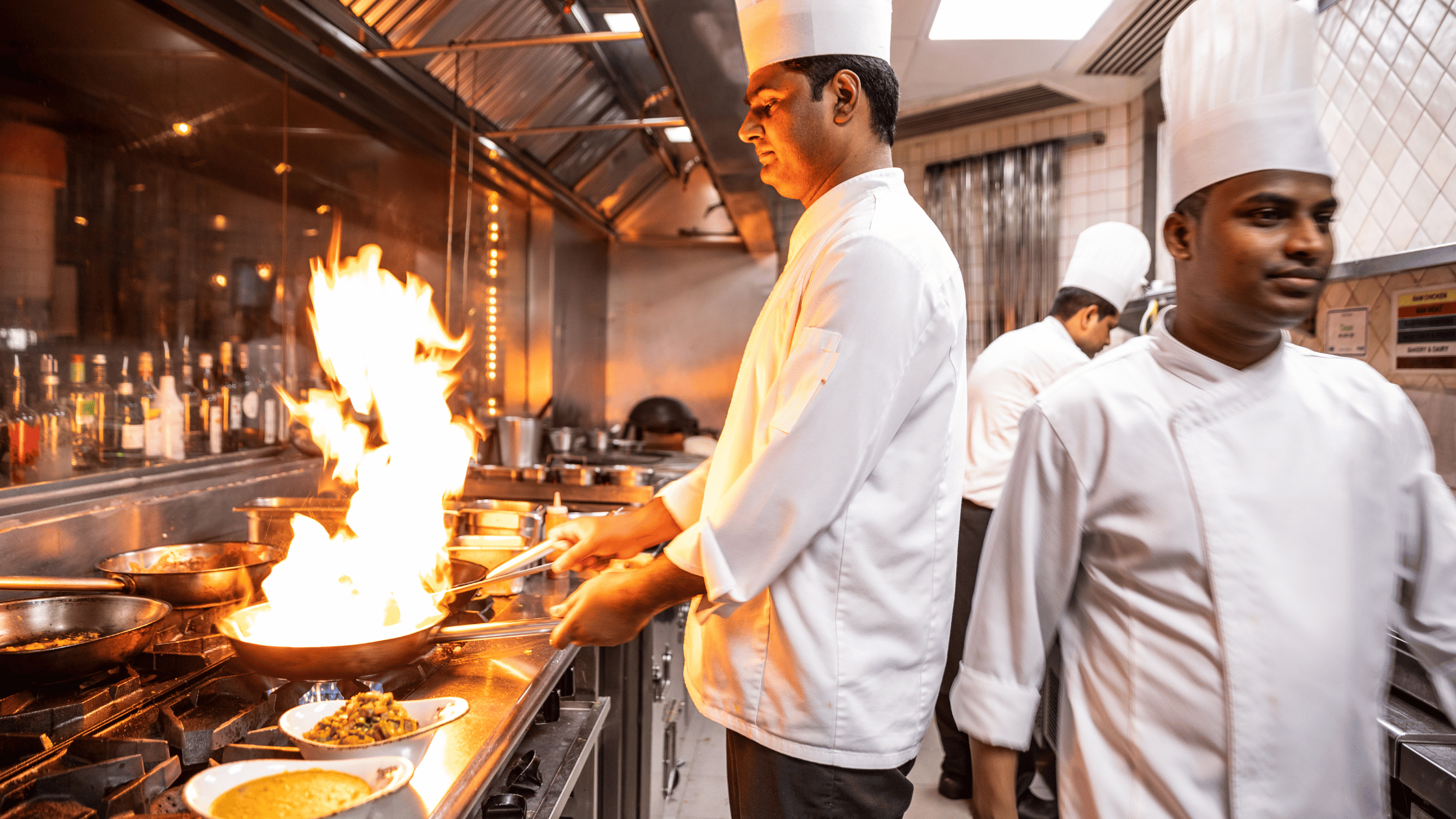 Group of Chefs cooking Indian food in the Restaurant's Kitchen