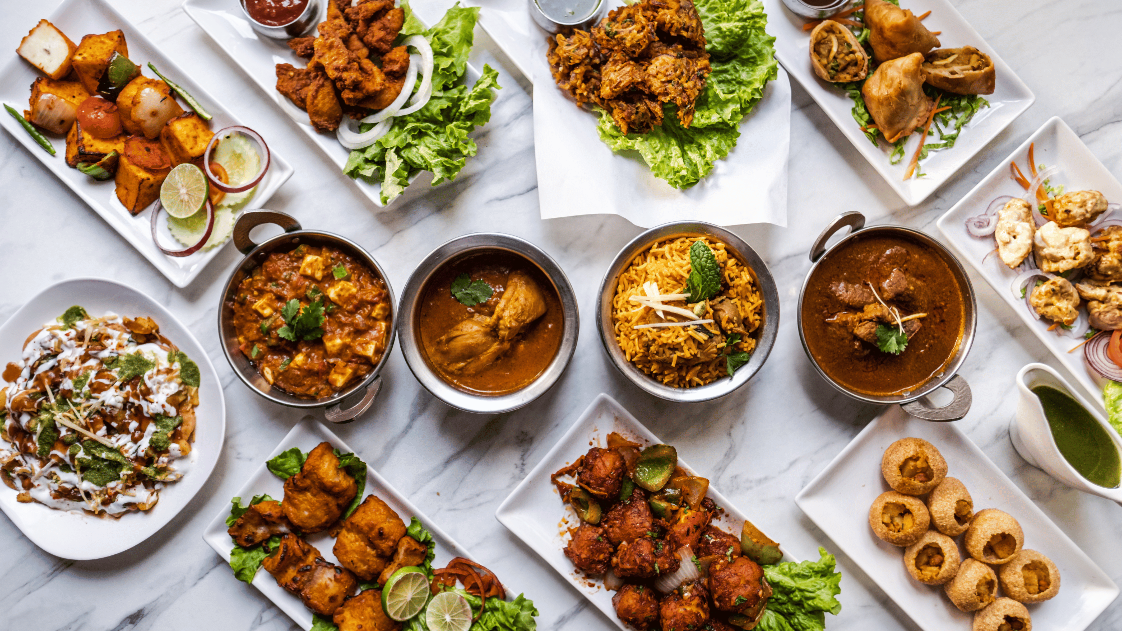 Indian foods orderly placed on the table top