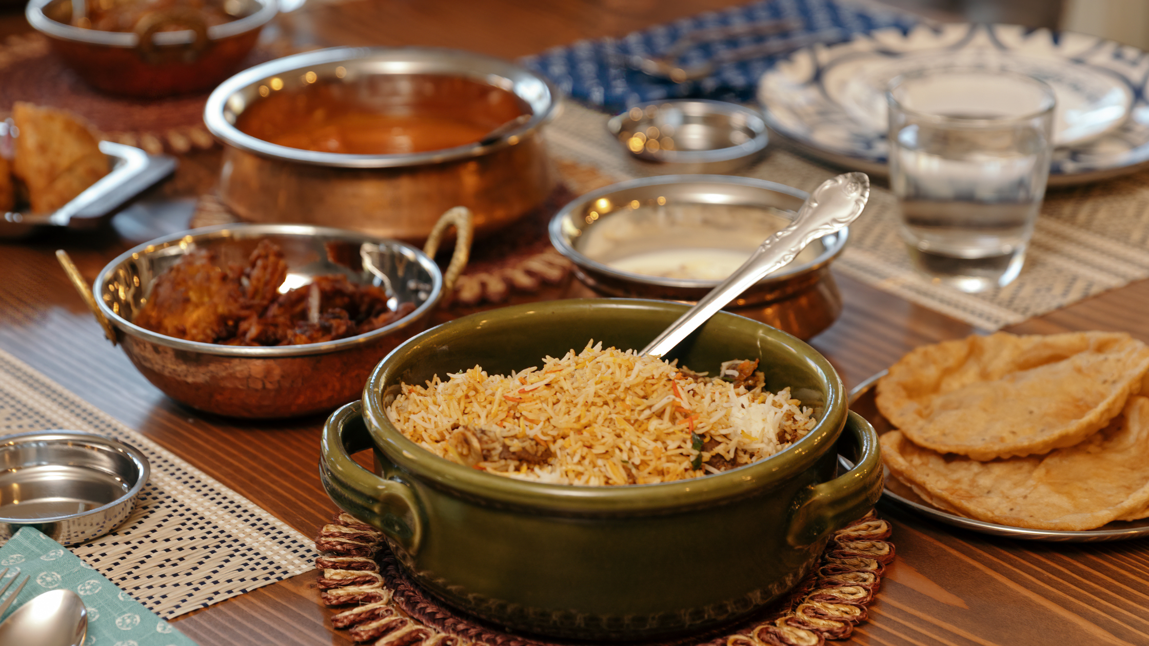 Authentic Indian meal featuring biryani, puri, curry, and sides served at Kuppanna Indian Restaurant in Texas